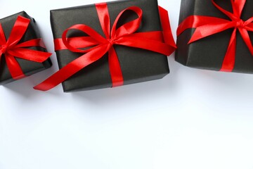 Beautiful gift boxes tied with bows on white background 