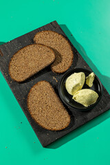 Rye bread with herb butter on cutting board