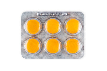 tablets lozenges in a blister pack for coughing in the throat white background