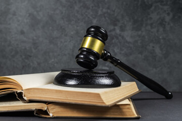 law concept, judge's gavel on top of open books, on dark background