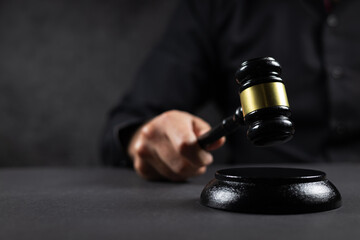 Judge hitting Gavel off a block in courtroom, law and Justice concept