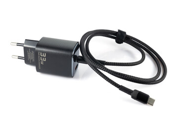 Charger with black plug on white background, charger with block, for smartphone