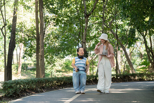Joyful Stroll in the Park Embracing Diversity and Friendship with a Person with Achondroplasia