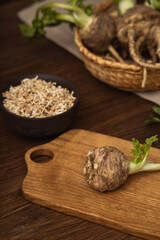 Celery root in close up on a cutting board, sliced dried root vegetable in a plate