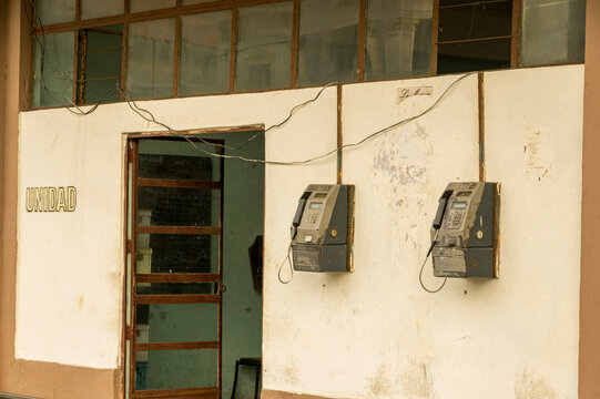 Old payphones on a weathered wall evoke nostalgia and history