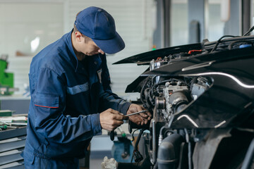 Auto mechanic repairs an engine. Replacing the timing chain