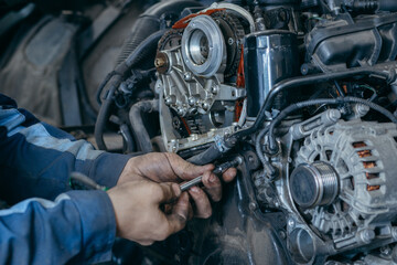 Auto mechanic repairs an engine. Replacing the timing chain