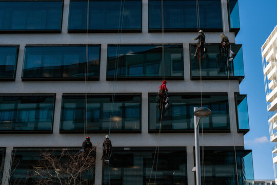 Workers Installing Pigeon Spikes on Skyscraper
