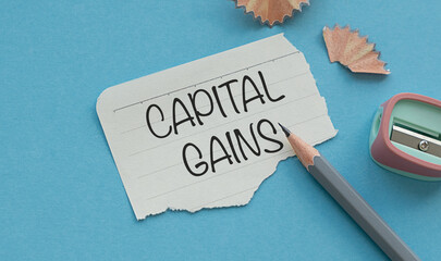 Capital Gains Text on Paper Sticker attached to notepad with pencil, business concept