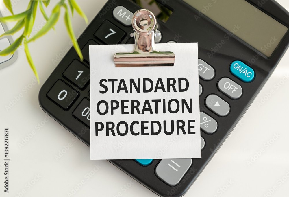 Aufkleber notepad with text standard operation procedure with calculator and pen. white background. business c