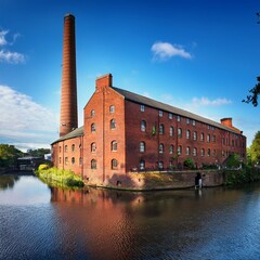 Obraz premium old red brick mill by the canal, in the UK, AI generated