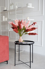 Pink and red flowers in living room interior