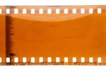 Dusty and grungy 35mm film texture or surface. Perforated scratched camera film isolated on white...