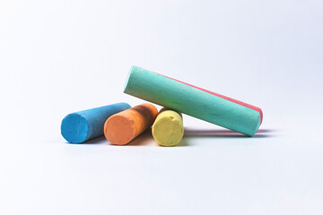 Crayons of different colors arranged on a white background. Education