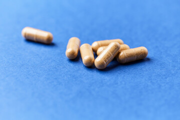 Korean Ginseng capsules. Concept for a healthy dietary supplementation. Bright paper background. Close up.	