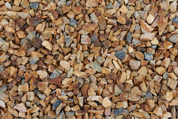Crushed gravel in tones of blue, grey and amber brown.