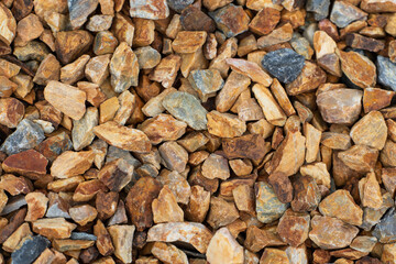 Closeup of crushed stone gravel in tones of blue, grey and amber brown