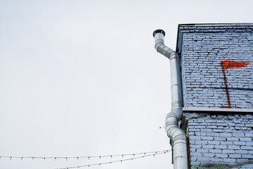 The structure is a substantial brick building with a vibrant red flag painted on its exterior,...