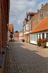 a beautiful city scape view through the small streets in the town Ribe in Denmark. With small and historic half-timbered houses in tiny alleys.