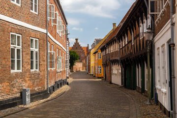 a beautiful city scape view through the small streets in the town Ribe in Denmark. With small and historic half-timbered houses in tiny alleys.
