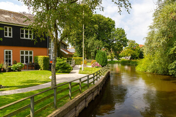 Fototapeta premium a beautiful small village view at the river through ribe, Denmark. 