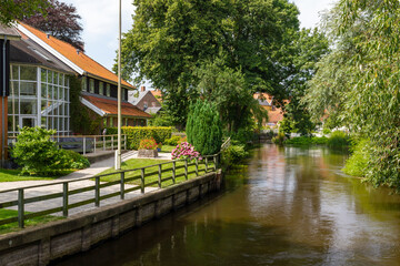 Obraz premium a beautiful small village view at the river through ribe, Denmark. 