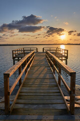 Obraz premium Wooden walkway of a pier at sunset in La Manga del Mar Menor. Murcia, Spain