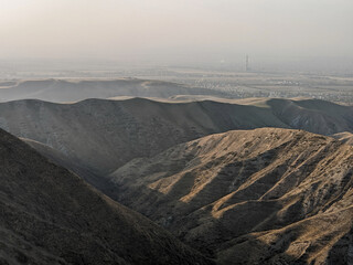View of landcape with mountains and hills at sunset. Natural scenery photo, travel photo. The city...