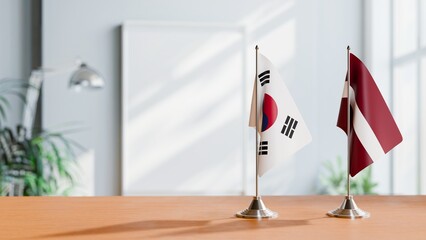 FLAGS OF KOREA SOUTH AND LATVIA ON TABLE © Vutuk
