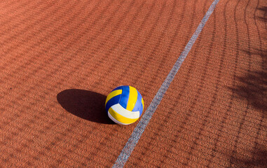 volleyball. blue with yellow color ball on the playground. volleyball cover, red. ball game