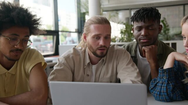 Class lesson in school university college library online project cooperation teamwork African American women girls students female Caucasian men guys male studying learn laptop computer discuss talk
