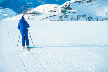 Young man athlete skiing in snow mountain - Skier riding down for winter sport competition - Travel and vacation concept - Focus on his body