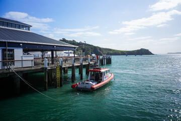 Naklejka premium Scenic Pier with Boat in Calm Waters