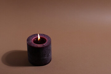 Wax natural aroma candle, candlelight in dark, dry tree trunk on background
