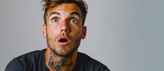 Portrait of a young man with short hair and light stubble.