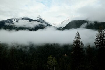Misty Mountain Landscape with Snow-Capped Peaks