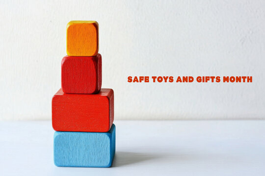 Stacked wooden blocks in vibrant colors celebrating Safe Toys and Gifts Month, promoting safety and thoughtful gift-giving.