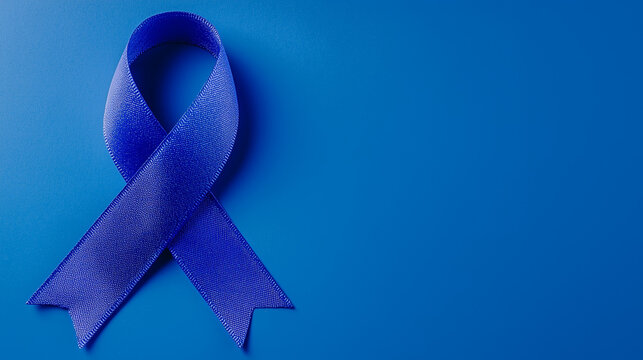 Blue cancer awareness ribbon on blue background