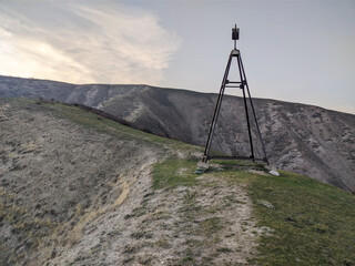 View of mountains landcape. Triangulation point, tower on top of the hill. Vivid natural scenery...