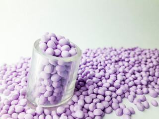 Lavender masterbatch granules on white background,color pigment carrier polymer in plastic industry,suitable for plastic company catalogue