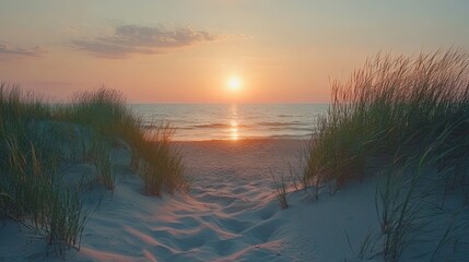 Sunset at sandy beach on Baltic sea. Sandy dune with grass on the sea coast at sunset. Travel destination 