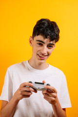 A teenager holds a controller to play video games.