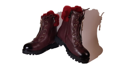 Autumn boots of red-brown color on a white background.
Warm boots with fur, zippers and decorative lacing.