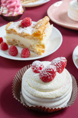 desserts with raspberries on white plates on the table