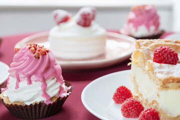 desserts with raspberries on white plates on the table