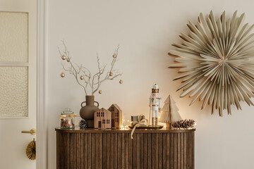 Wooden cabinet with Christmas decor, nutcracker, and wrapped gifts. Elegant and festive interior...