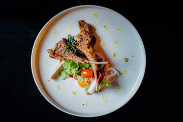  Food styling , A white plate of grilled rack of lamb  
