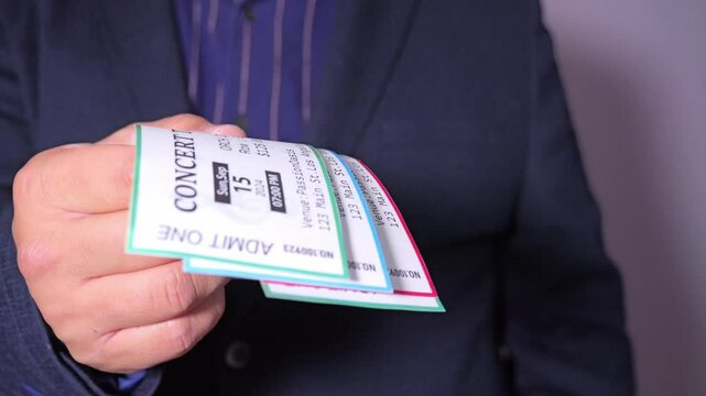 A man is engaged in ticket scalping, selling concert tickets at a significantly higher price than face value,The concept of scalpers