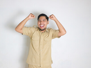 Asian male Indonesian civil servants wearing brown uniforms; usually called keki; look very happy by showing gestures of success in achieving something. Indonesian civil servants; ASN