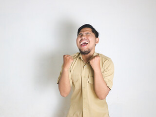 Asian male Indonesian civil servants wearing brown uniforms; usually called keki; look very happy by showing gestures of success in achieving something. Indonesian civil servants; ASN